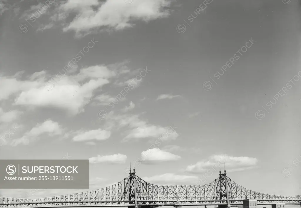 Vintage photograph. Clouds in sky above bridge at bottom