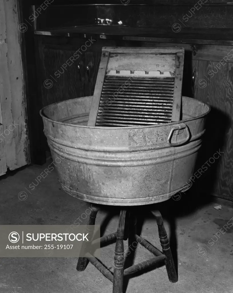 Close-up of a washboard and a wash tub on a stool