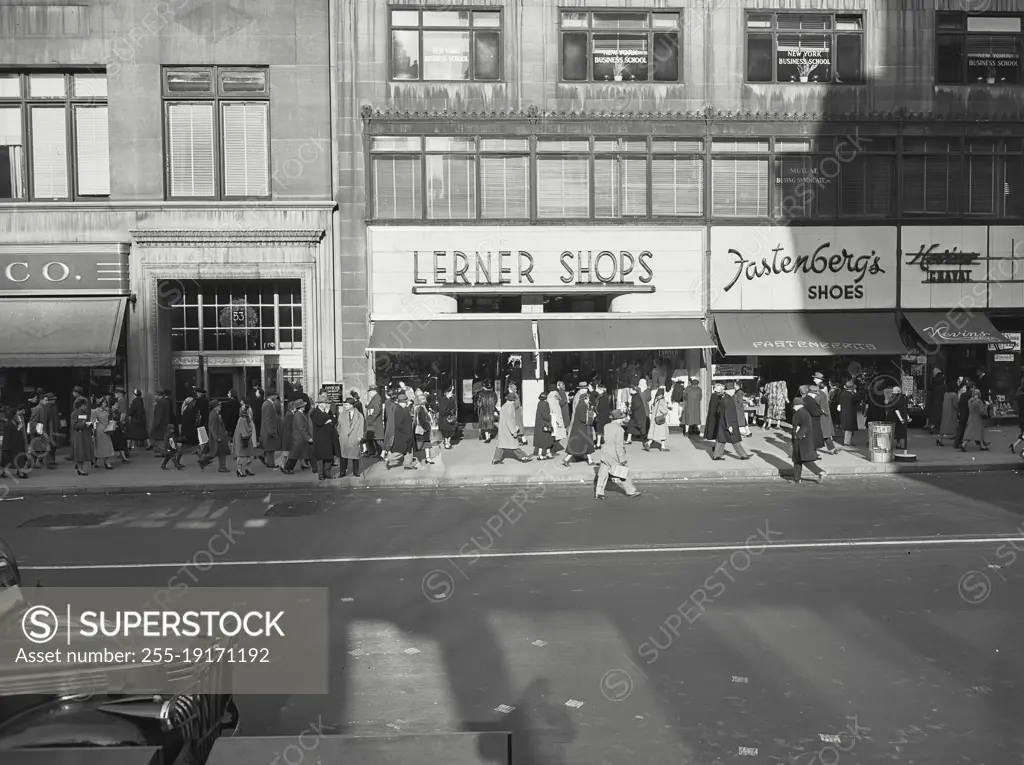 Vintage photograph. crowd walking in front of Lerner shoes in new York city