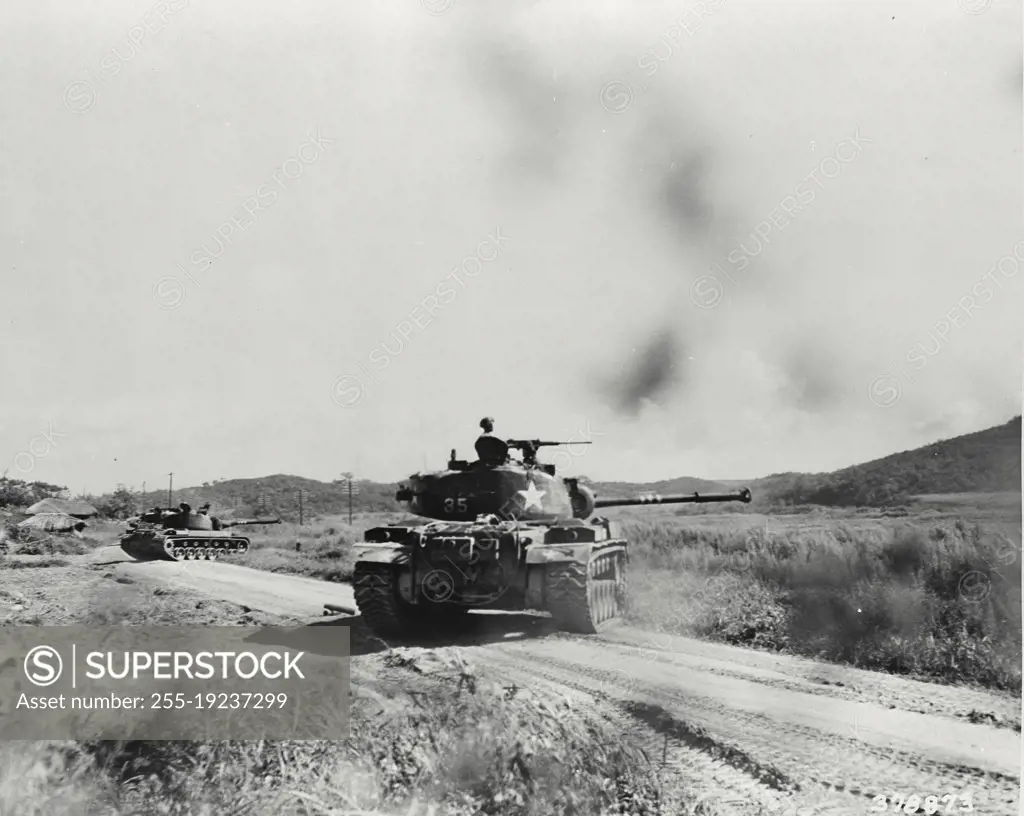 Vintage photograph. Units of a tank battalion move down the road to support infantrymen attempting to rout Communist positions on a hill in Korea