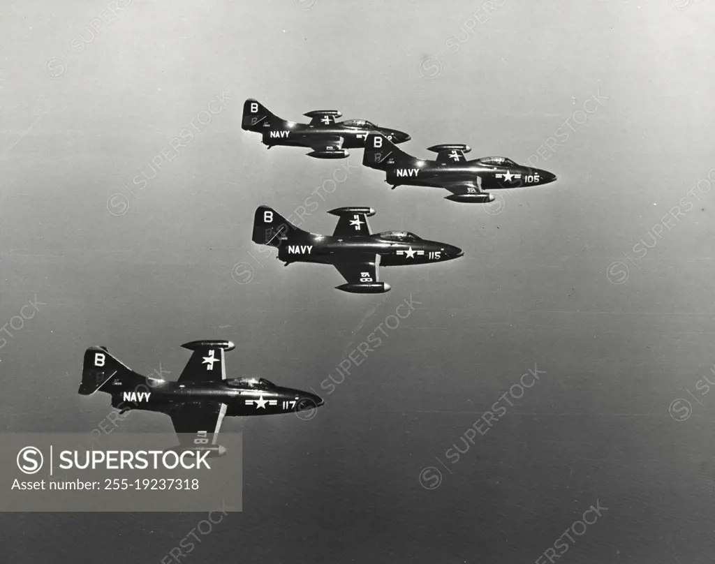 Vintage photograph. Four US Navy Panther Jets fly close formation