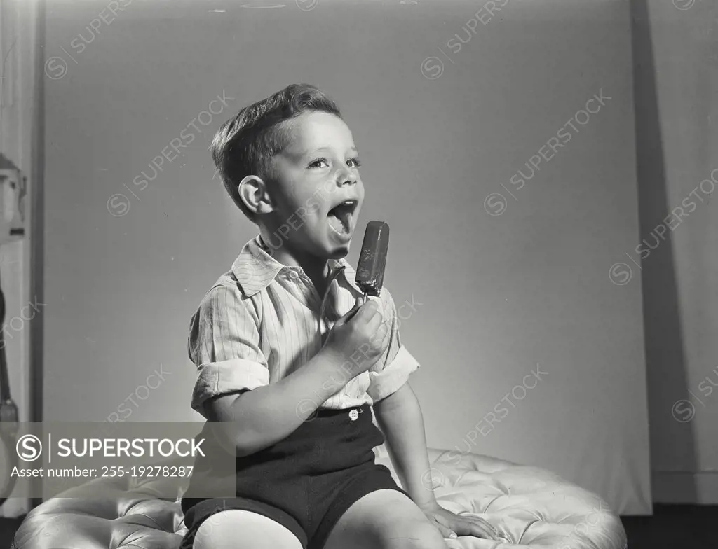 Vintage photograph. Little boy with ice cream pop.