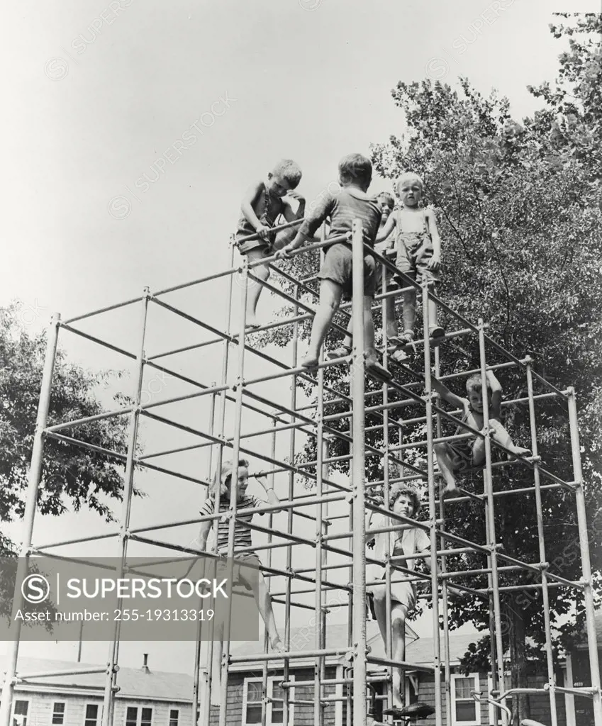 Vintage photograph. Children playing on jungle gym at Broad Creek Village Public Housing in Norfolk, Virginia