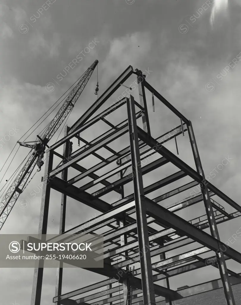 Vintage photograph. Crane carrying steel beams