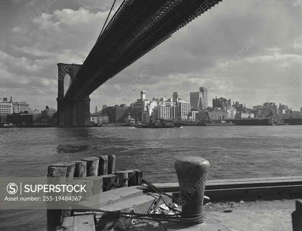 Vintage photograph. Brooklyn skyline as seen from lower Manhattan under the Brooklyn Bridge