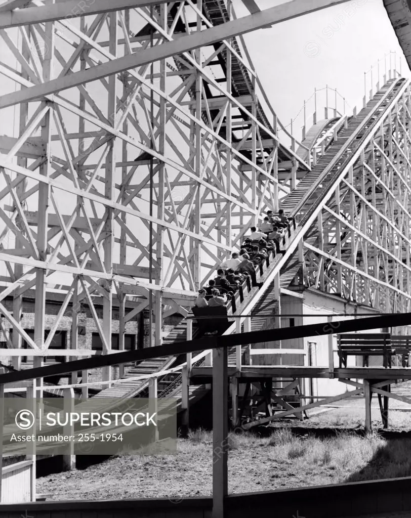 Low angle view of a group of people riding on a roller coaster, Coney Island, Brooklyn, New York City, USA