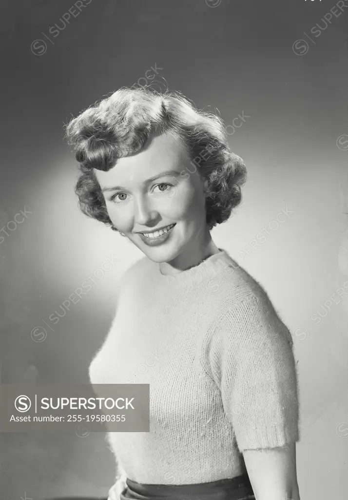 Vintage photograph. Portrait of woman in sweater smiling.