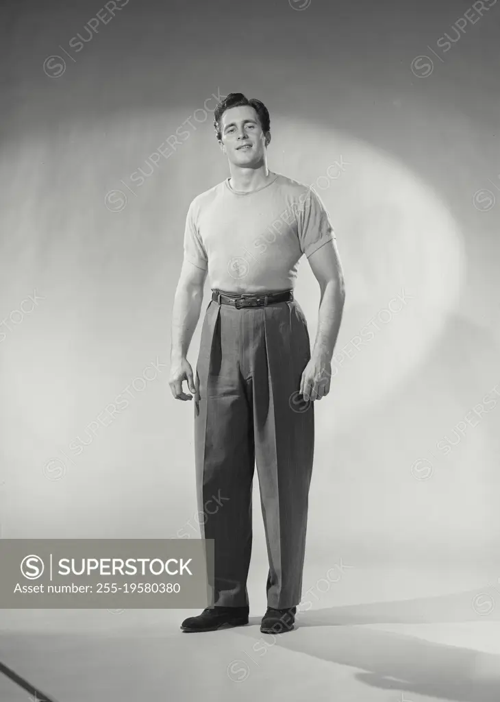 Vintage photograph. Man with shirt tucked in smirking