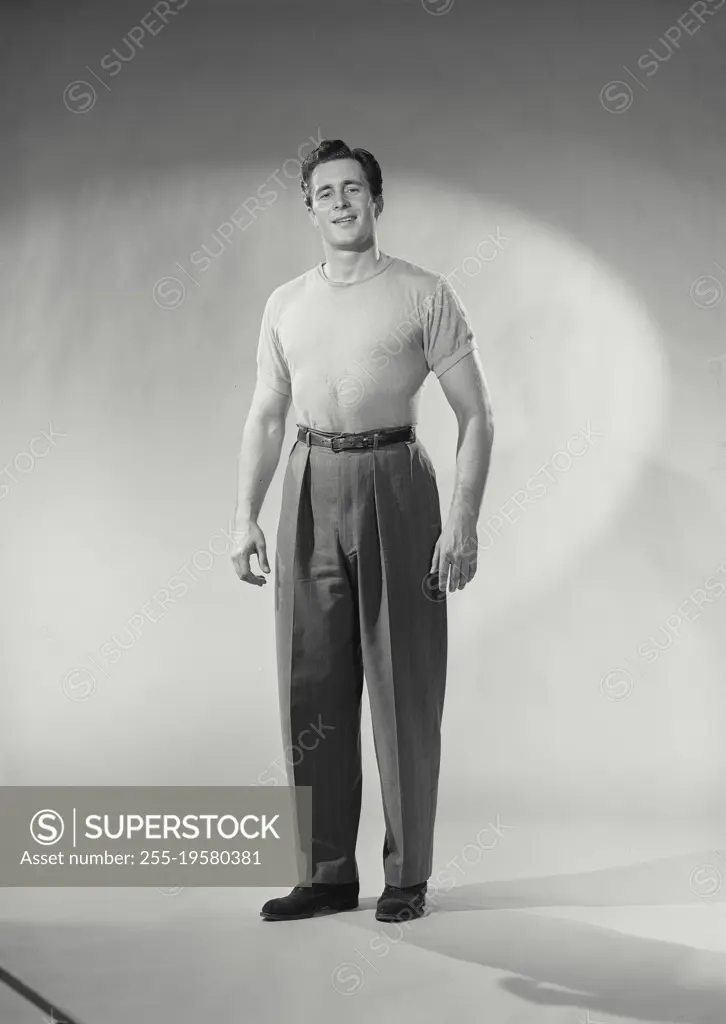 Vintage photograph. Man with shirt tucked in smirking