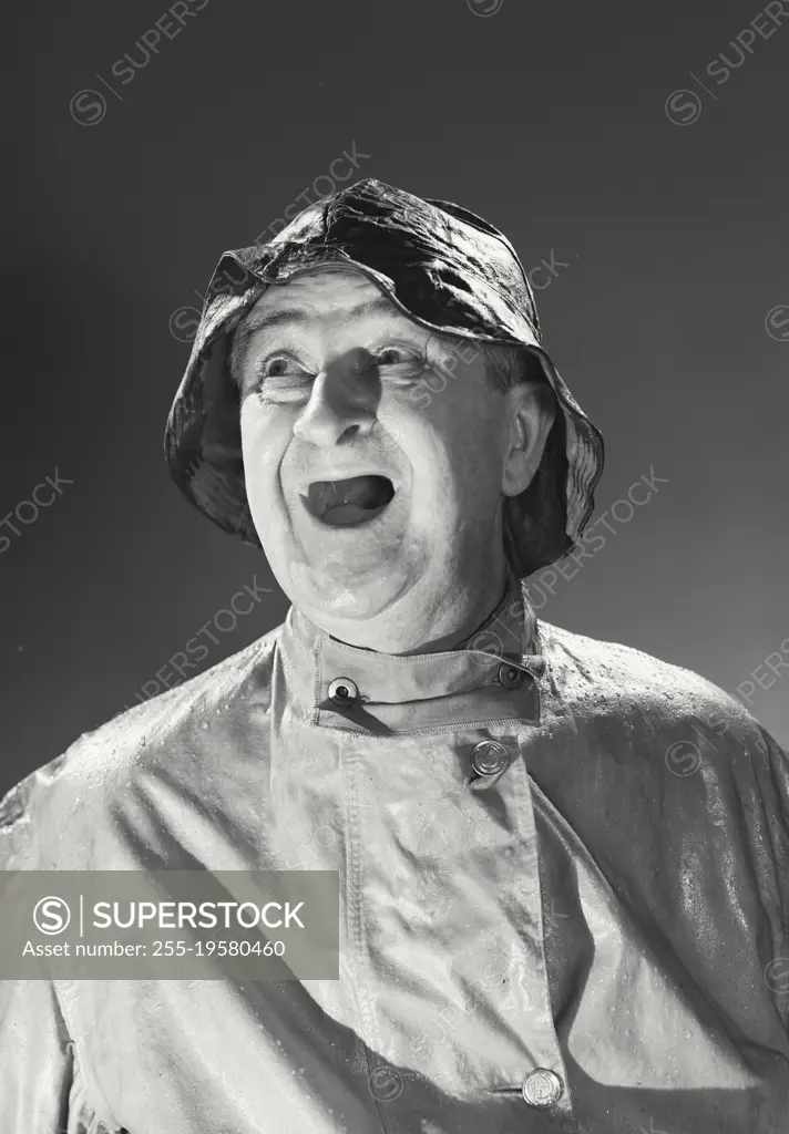 Vintage photograph. Man in rain hat and rain coat