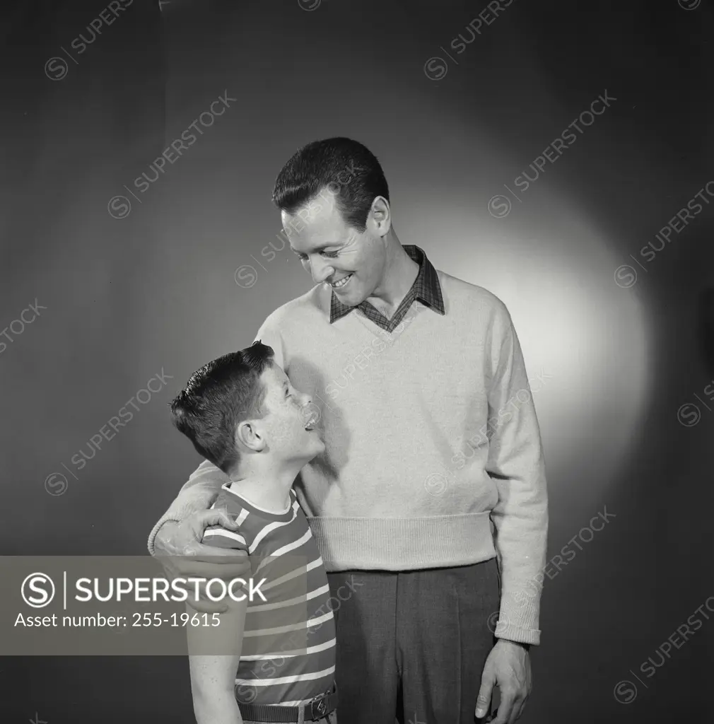 Vintage Photograph. Father standing with arm around son. Frame 3