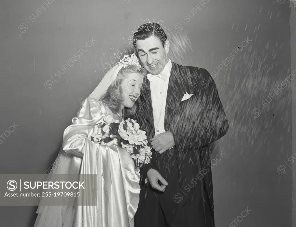 Vintage photograph. Man and Wife being showered with rice at wedding 