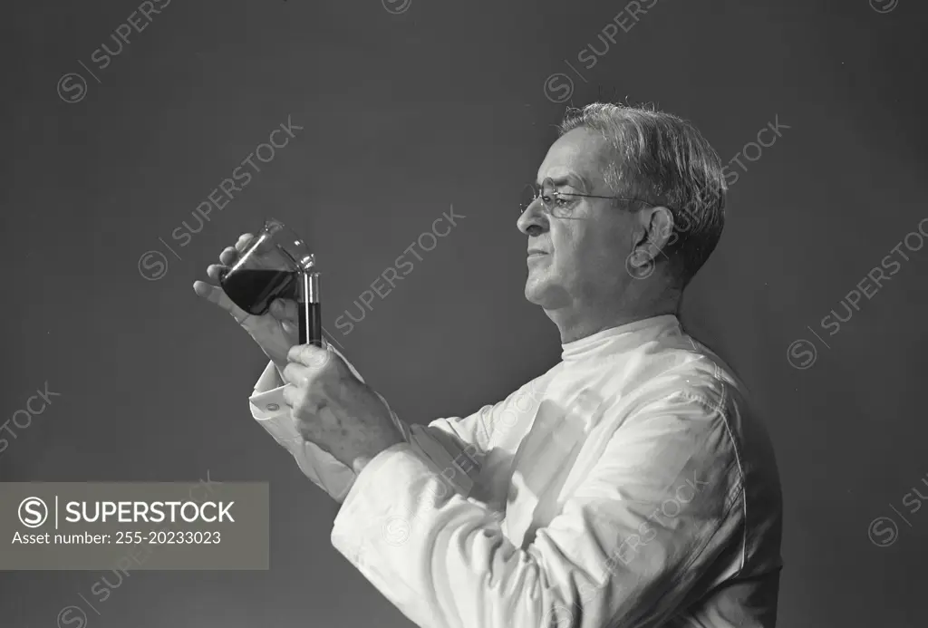 Scientist transferring liquid from one container to another