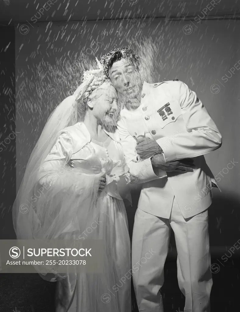 Man and wife being showered with rice during wedding