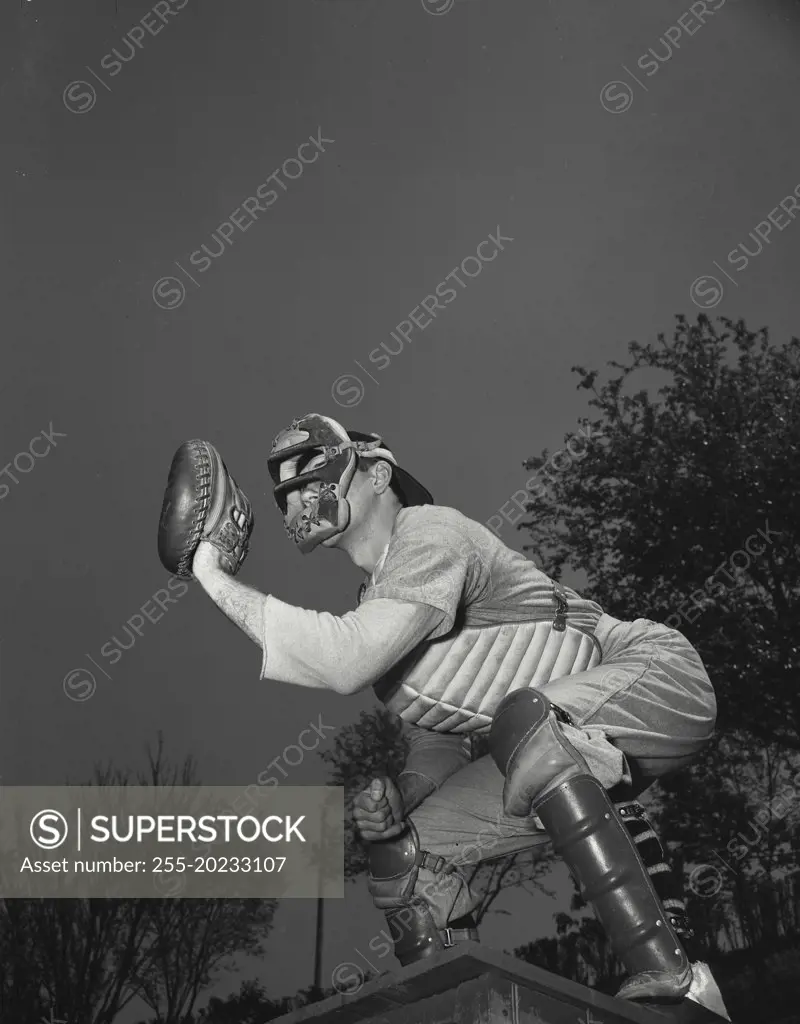 Baseball catcher holding up mitt ready to catch