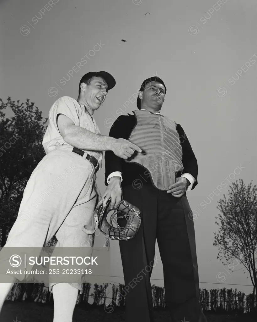 Baseball player and umpire arguing over play