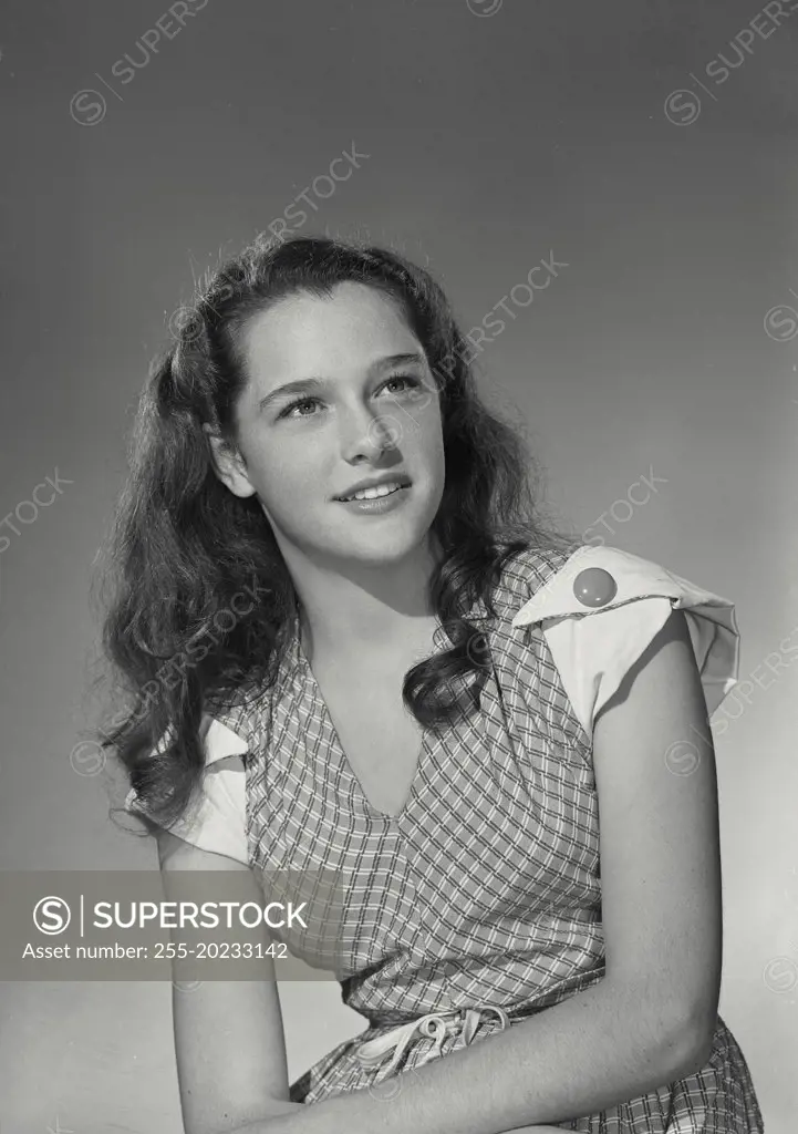 Woman in dress smiling off camera