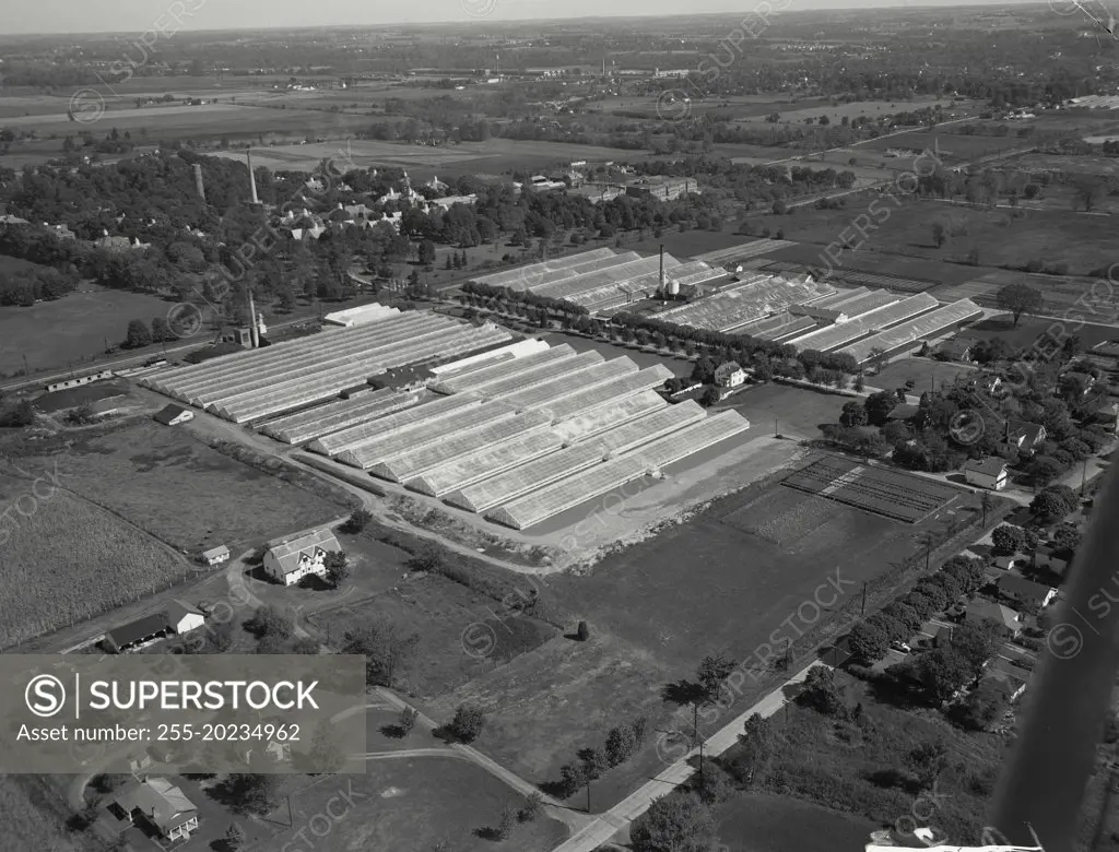 Aerial view of Richmond, Indiana. On the left is the EG Hill Company, rose growers. ON the right is Jos H Hill Company, also rose growers. In the distance is the Eastern Indiana Hospital for the Insane