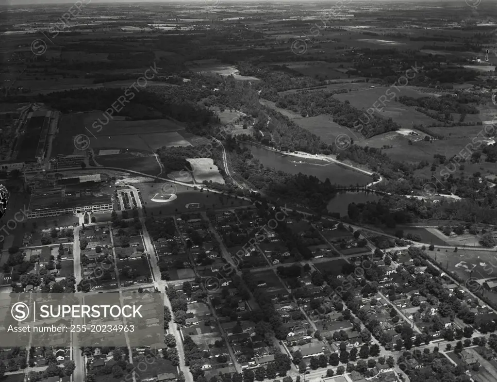 Aerial view of Richmond, Indiana. On the left is the Crosley Corporation, refrigerators. Also left, the Belden Corporation with its own ball park. On the right is an artificial lake with swimming and fishing, Wayne County Conservation Club. State Highway 38 running through middle