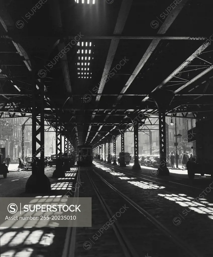 View under 3rd Avenue elevated at 47th St showing railway and train