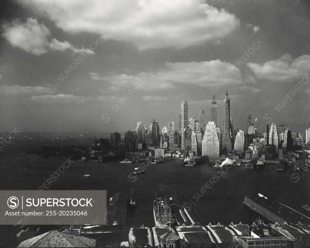 The New York City skyline seen from Brooklyn with clouds in sky