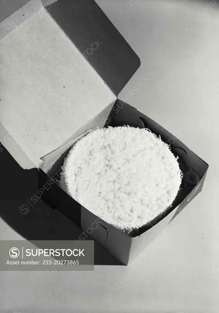 Vintage photograph. Coconut cake placed in box for delivery