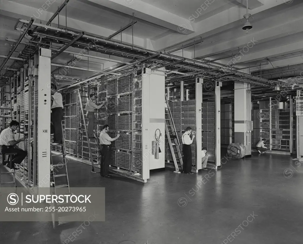 Vintage photograph. Men installing "crossbar" dial central office