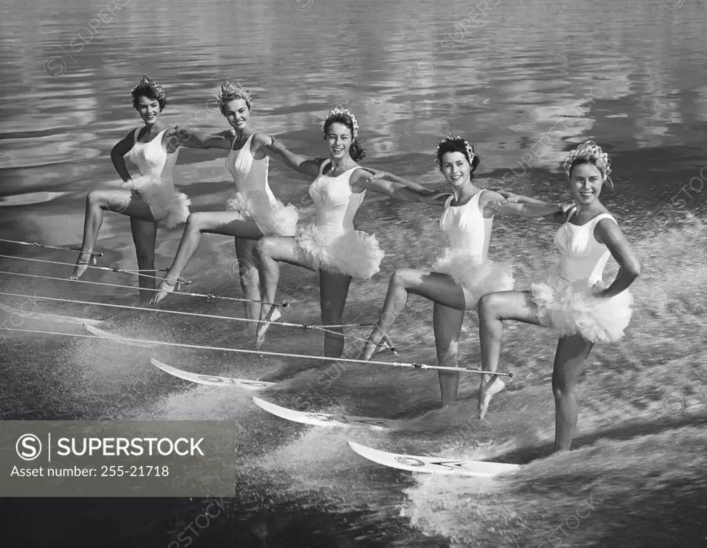 Five young women waterskiing