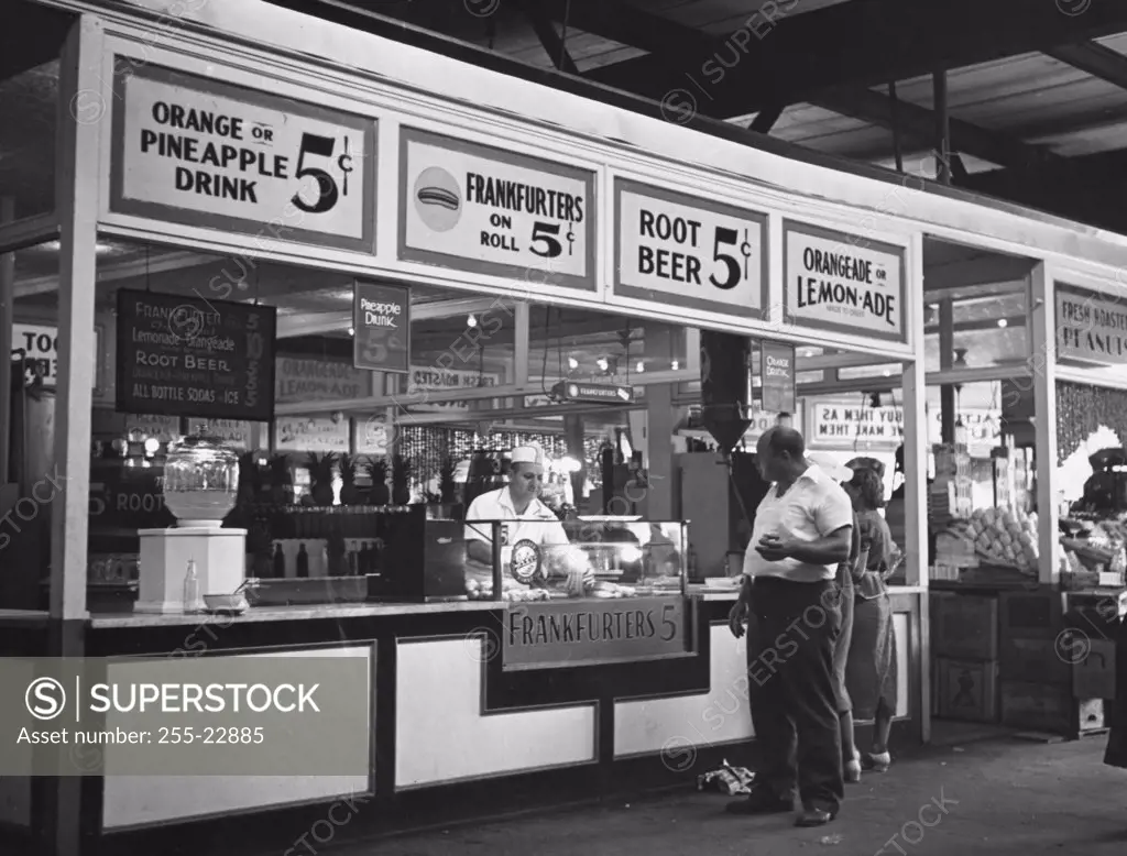 Customer standing in front of a food vendor, Coney Island, New York City, New York State, USA