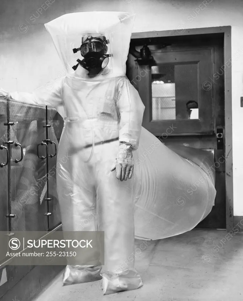 Scientist wearing an atomic suit and standing in a nuclear power station