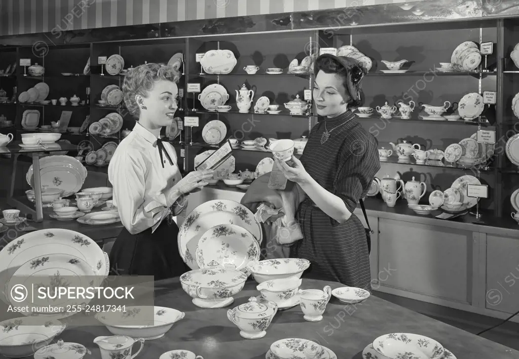 Vintage Photograph. Woman shopping for new dinnerware