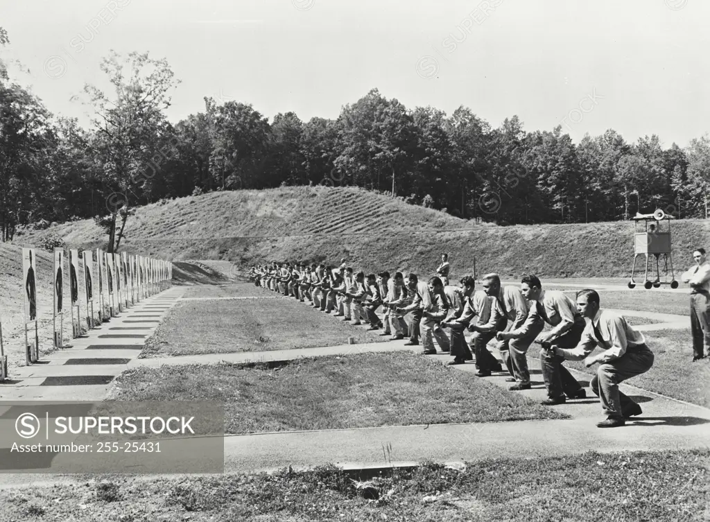 Vintage photograph. Special agents engaging in hip shooting practice on one of the firearm ranges at the FBI academy, Quantico, Virginia