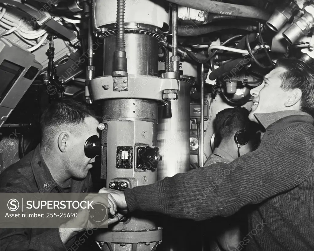 Vintage photograph. Army soldiers using the periscope in a submarine