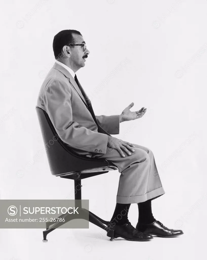 Side profile of a businessman sitting on an office chair