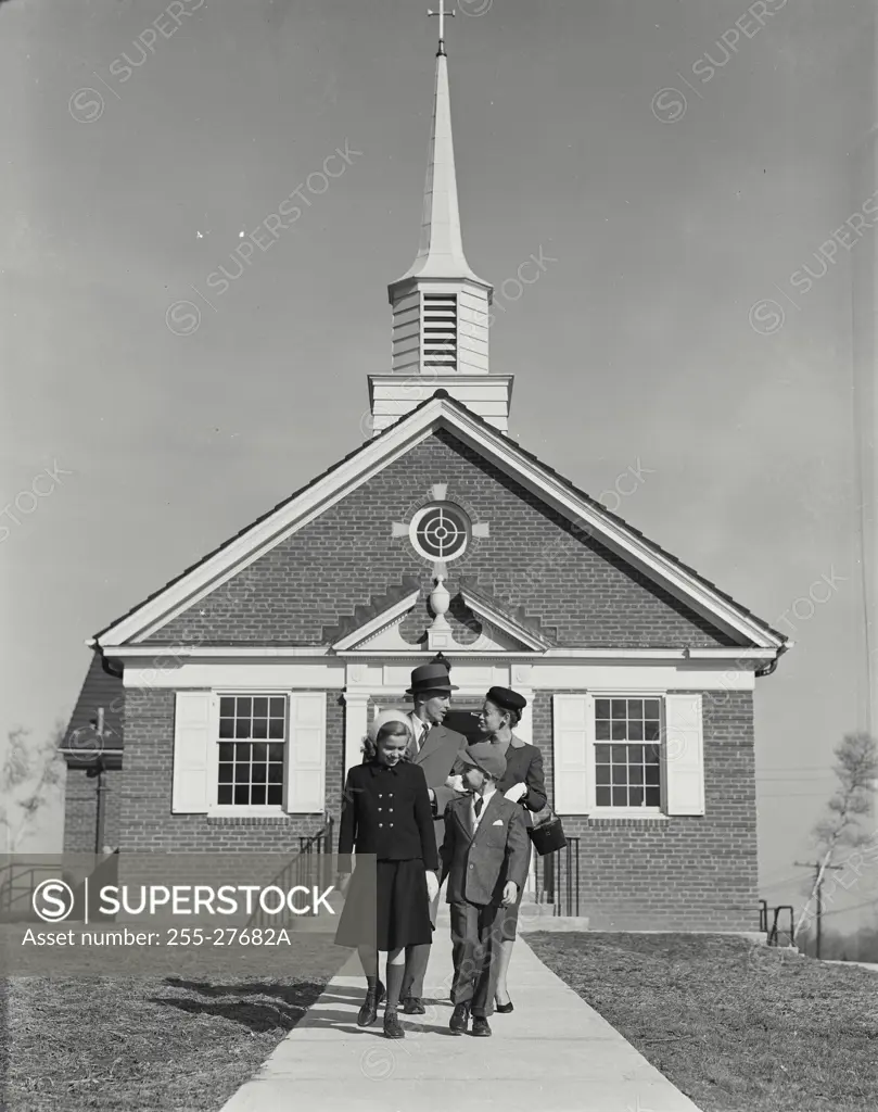 Vintage Photograph. Well dressed family of four walking away from small church Frame 7