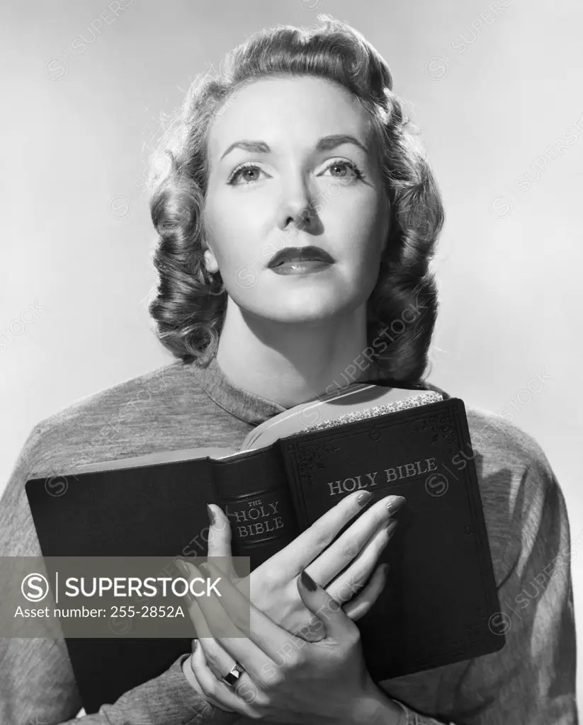 Close-up of a young woman holding the Bible