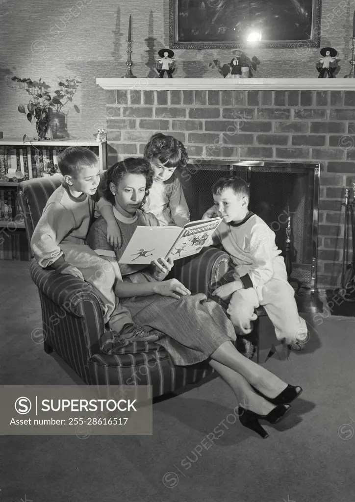 Vintage Photograph. Mother reading to her children in living room. Frame 3