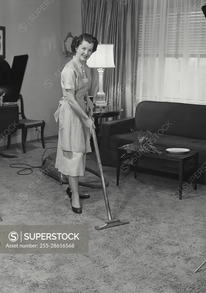 Vintage Photograph. Nellie Jane Cannon. Model Released. Woman vacuuming the living room. Frame 3