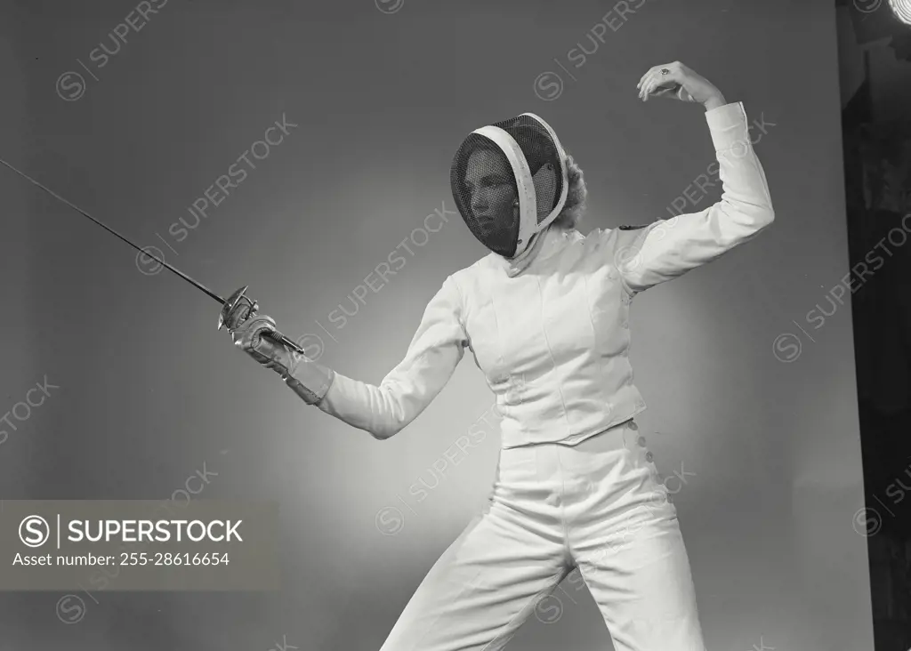 Vintage Photograph. Woman in fencing gear holding out saber in fighting stance. Frame 4