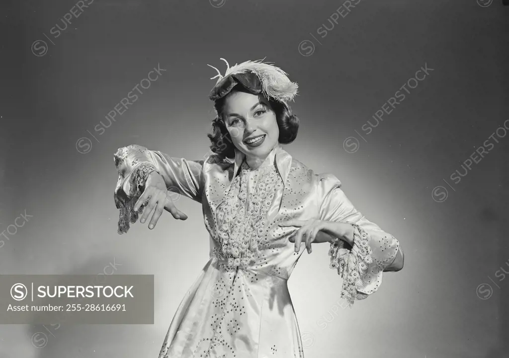 Vintage Photograph. Woman in long gown and feathered hat on white background. Frame 6