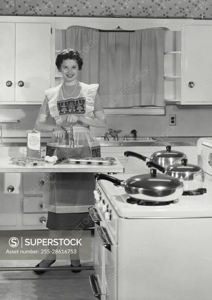 Vintage Photograph. Young matron seen preparing dinner. Frame 5