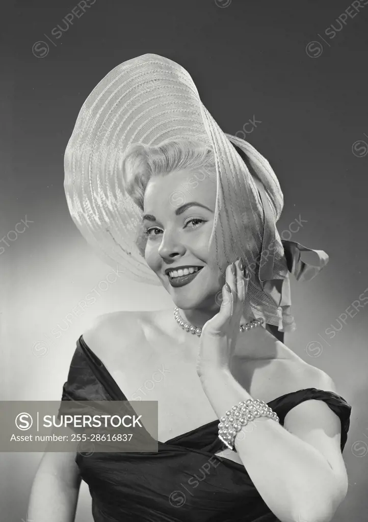 Vintage Photograph. Woman in dress wearing large hat. Frame 1