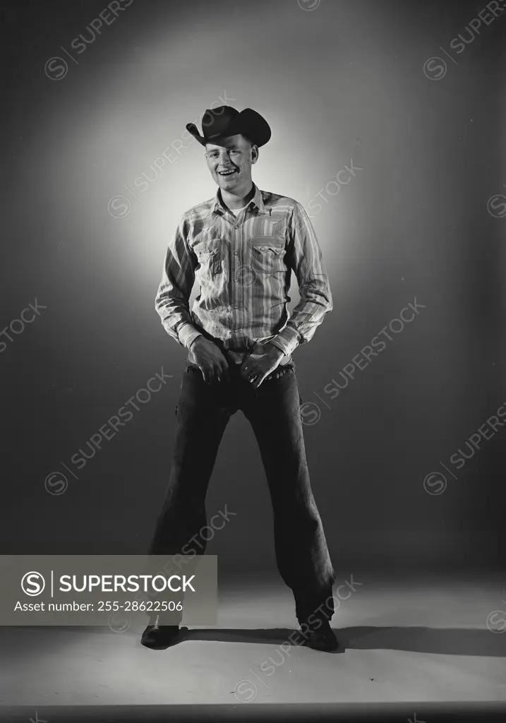 Vintage Photograph. Man in western wear with hands on belt buckle. Frame 2