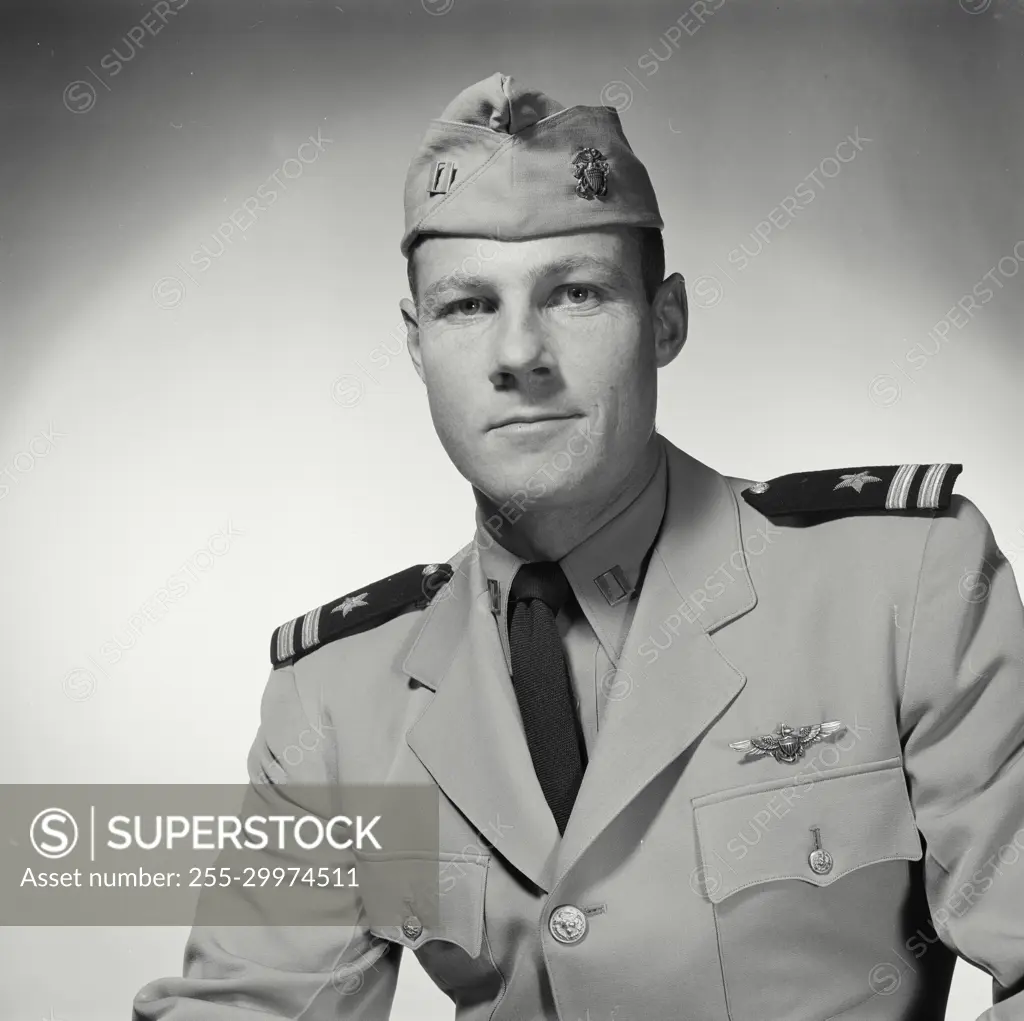 Vintage Photograph. Soldier in formal wear poses in studio portrait.