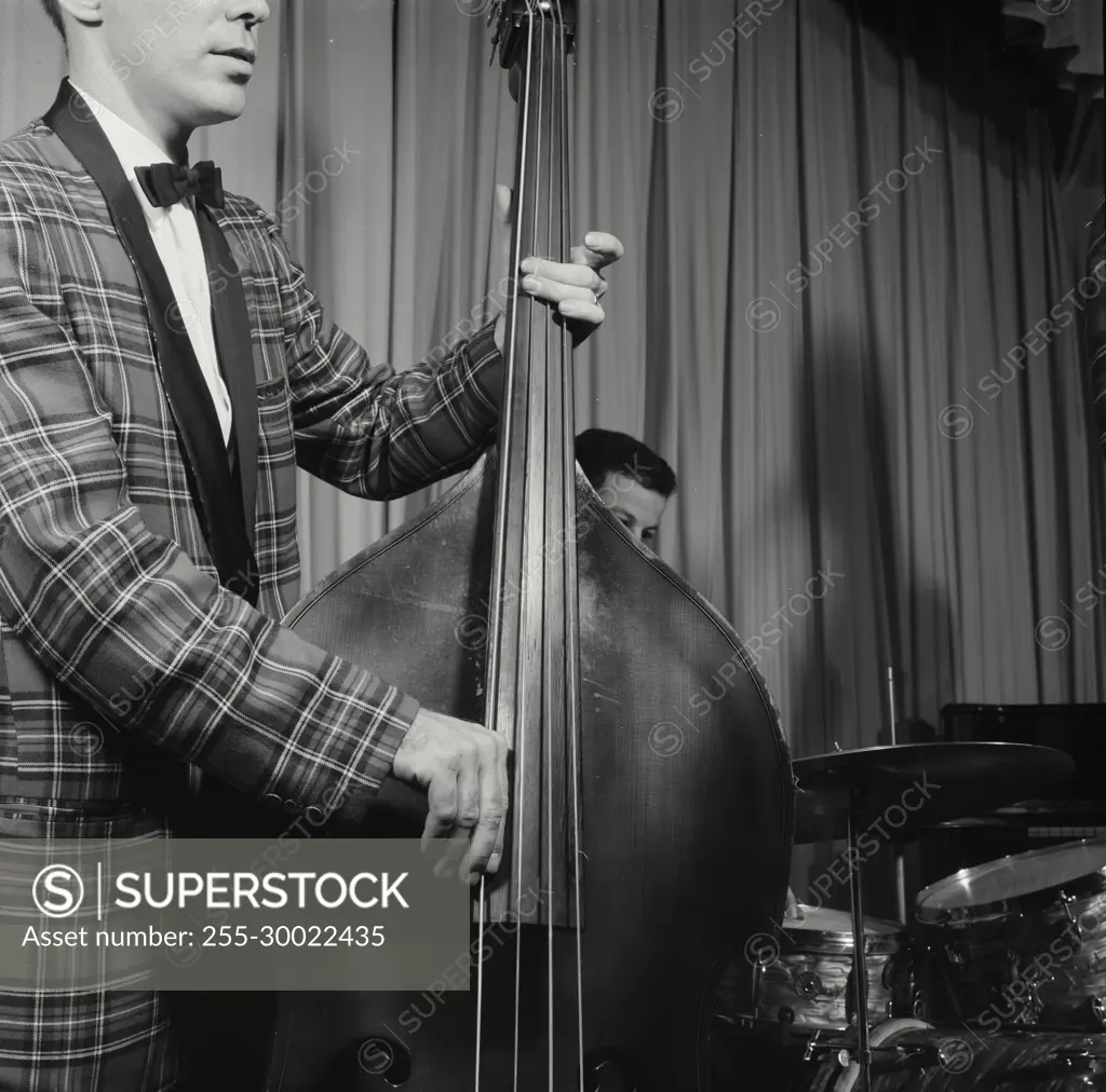 Vintage Photograph. Closeup of man playing bass.