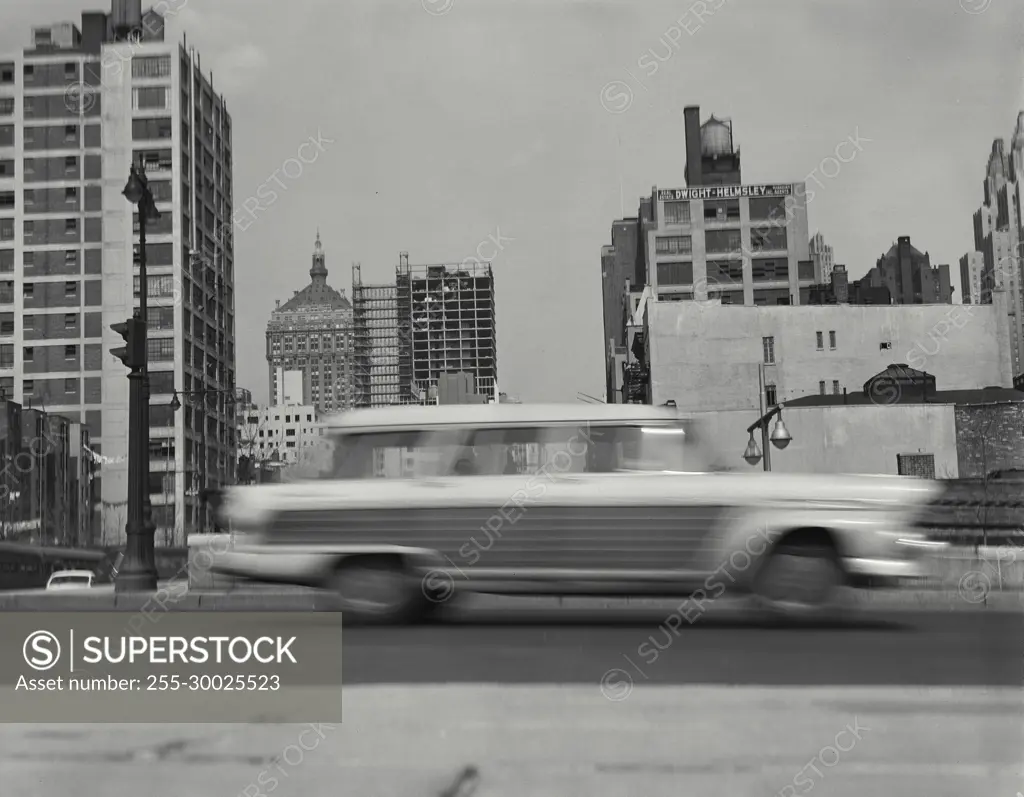 Vintage Photograph. Speeding automobile on New York City Street with buildings in background, Frame 5