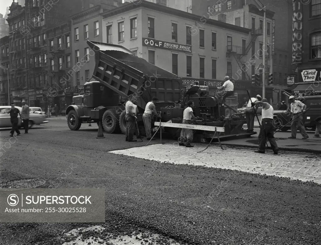 Vintage Photograph. Male workers spreading asphalt on resurfacing of Third Avenue, New York City