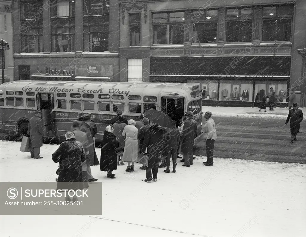 Vintage Photograph. People boarding bus on Fifth Avenue during snowstorm, New York City