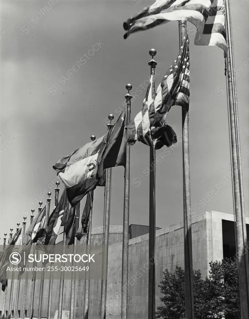 Vintage Photograph. Row of flags waving on flagpoles near United Nations building, New York City, Frame 2