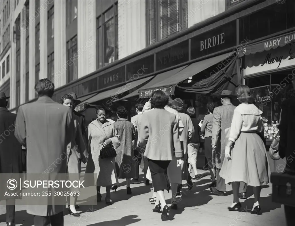 Vintage Photograph. Pedestrians walking on sidewalk near shops, New York City